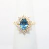 Picture of 14k Yellow Gold & 1.6ct Oval Cut Blue Topaz Ring with Diamond Halo