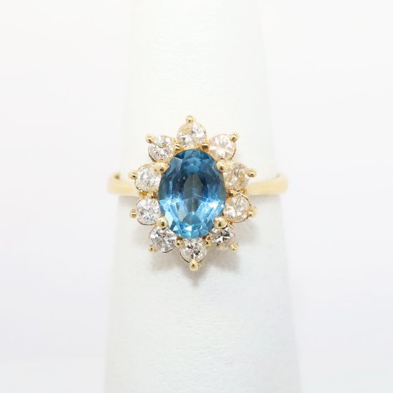 Picture of 14k Yellow Gold & 1.6ct Oval Cut Blue Topaz Ring with Diamond Halo