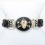 Picture of AXION Men's Braided Black Leather & Sterling Silver Bracelet with 14k Yellow Gold Skull & Crossbones  