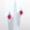 Picture of 14k White Gold & Oval Cut Ruby Huggie Earrings with Diamond Halos