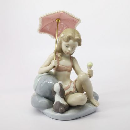 Picture of Lladro #6012 Monday's Girl Figurine Of Girl At The Beach With Parasol & Puppy From The Days Of The Week Collection.